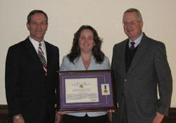 From left, Joint Warfare Analysis Center executive director Robert Tolhurst, sociology professor Jennifer A. Johnson and Robert D. Holsworth, Ph.D., acting dean of VCU's College of Humanities and Sciences, celebrate Johnson's recognition from the Joint Chiefs of Staff.

Photo by Mike Porter, University News Services