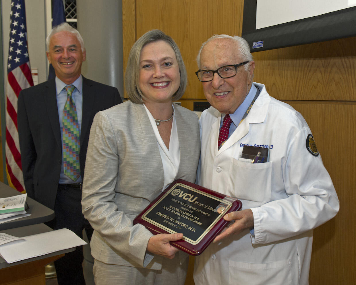 Enrique Gerszten, M.D., with Kimberly W. Sanford, M.D., associate professor in the Department of Pathology. Peter Buckley, M.D., dean of the School of Medicine, is in the background.