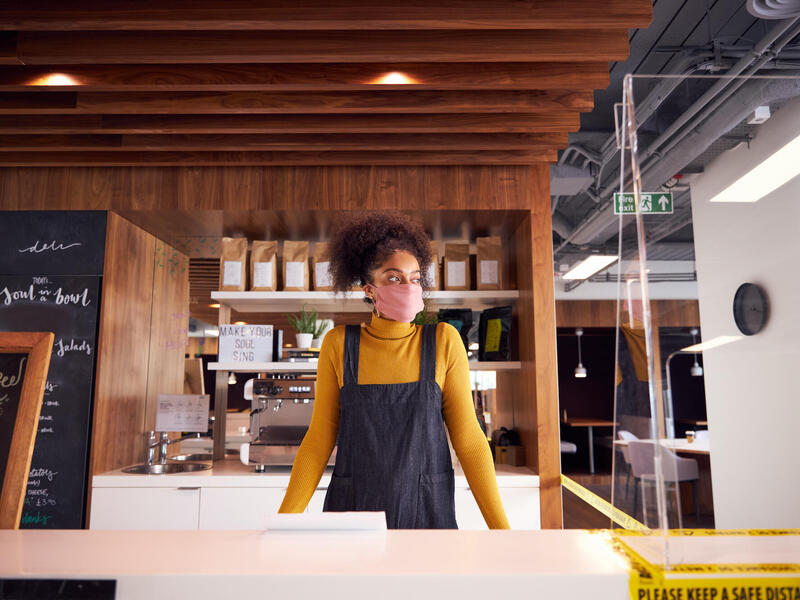 Black woman business owner standing in her market