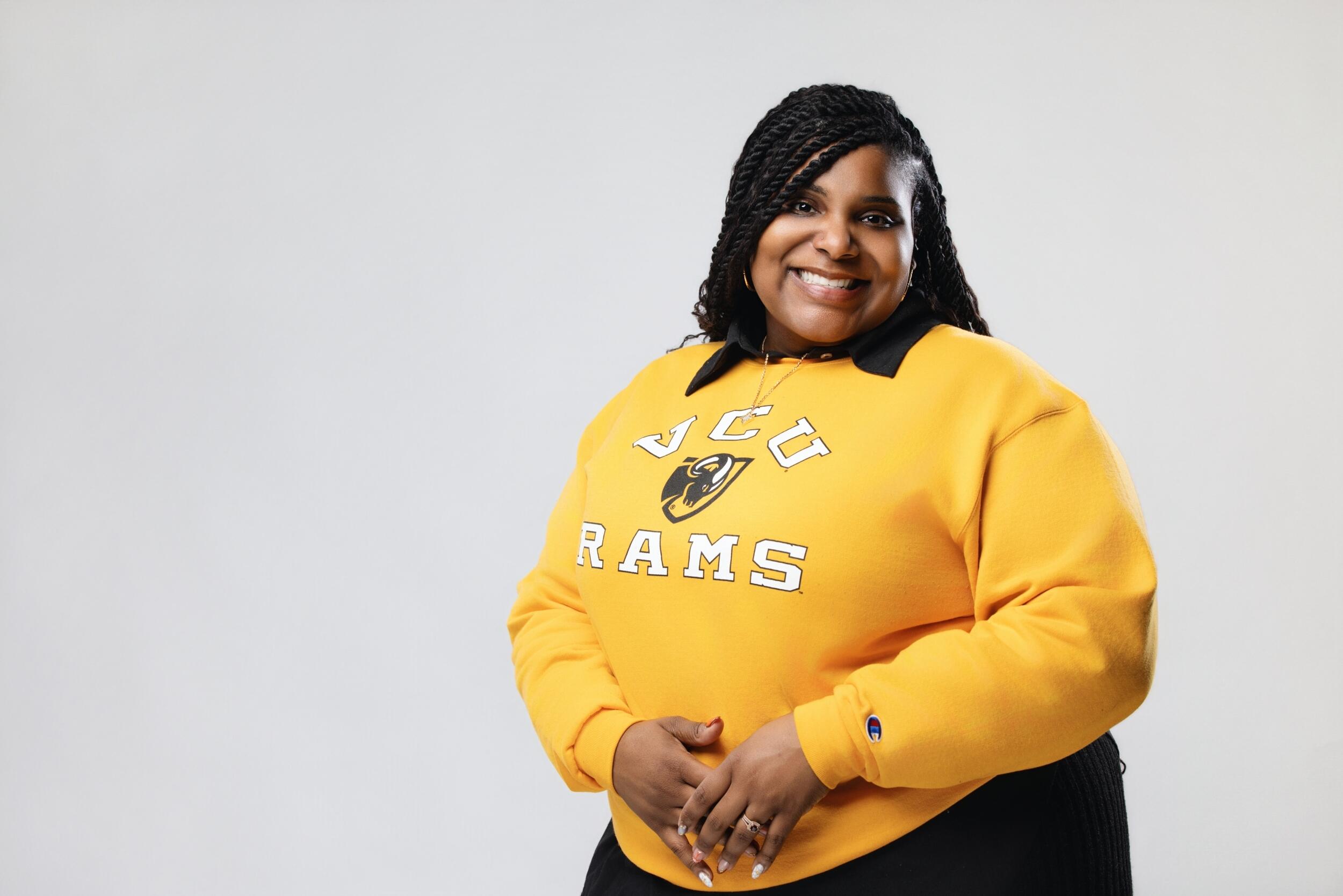 A photo of a woman standing from the waist up. 