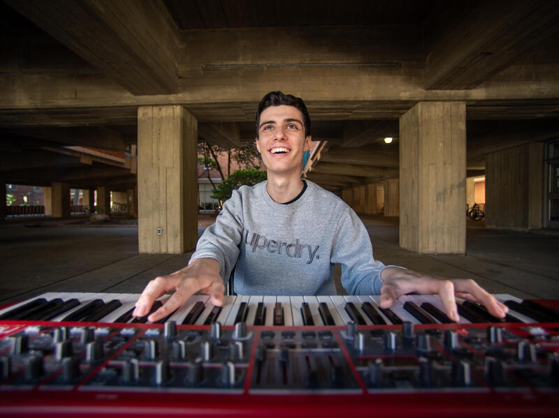 A photo of a man playing a keyboard.