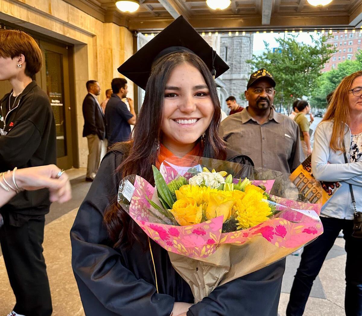 A photo of a woman wearing a graduation cap and gown 