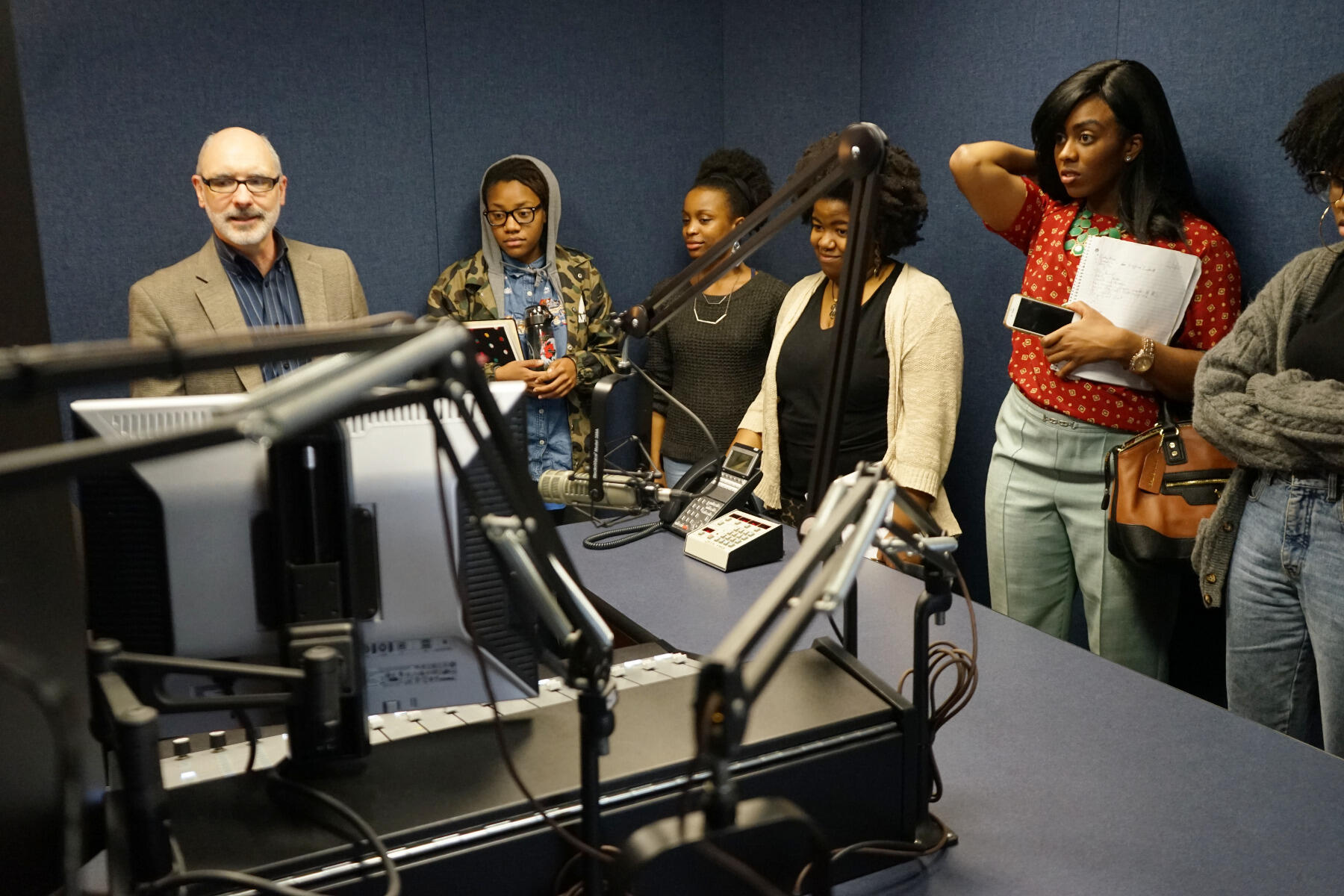 Bill Miller, vice president and general manager of  88.9 WCVE Public Radio, shows the "Podcasting While Black" students the NPR member station's studio during a recent field trip.

