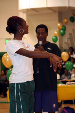 A student learns some simple exercises from Gene Townsel, a personal trainer at American Family Fitness, during Young Women’s Health Day. Photo by Martha M. Bushong, M.S., VCU School of Dentistry