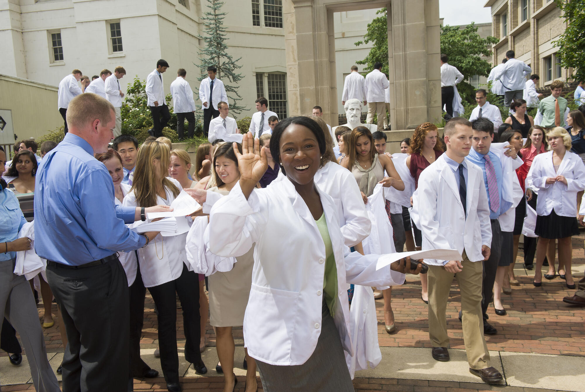 First-year medical students don white coats during a ceremony held at the start of the school year. (Photo by Allen Jones, University Relations)