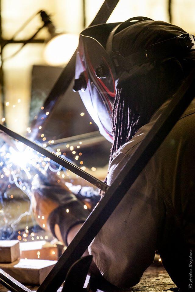 A welder working in a shop.