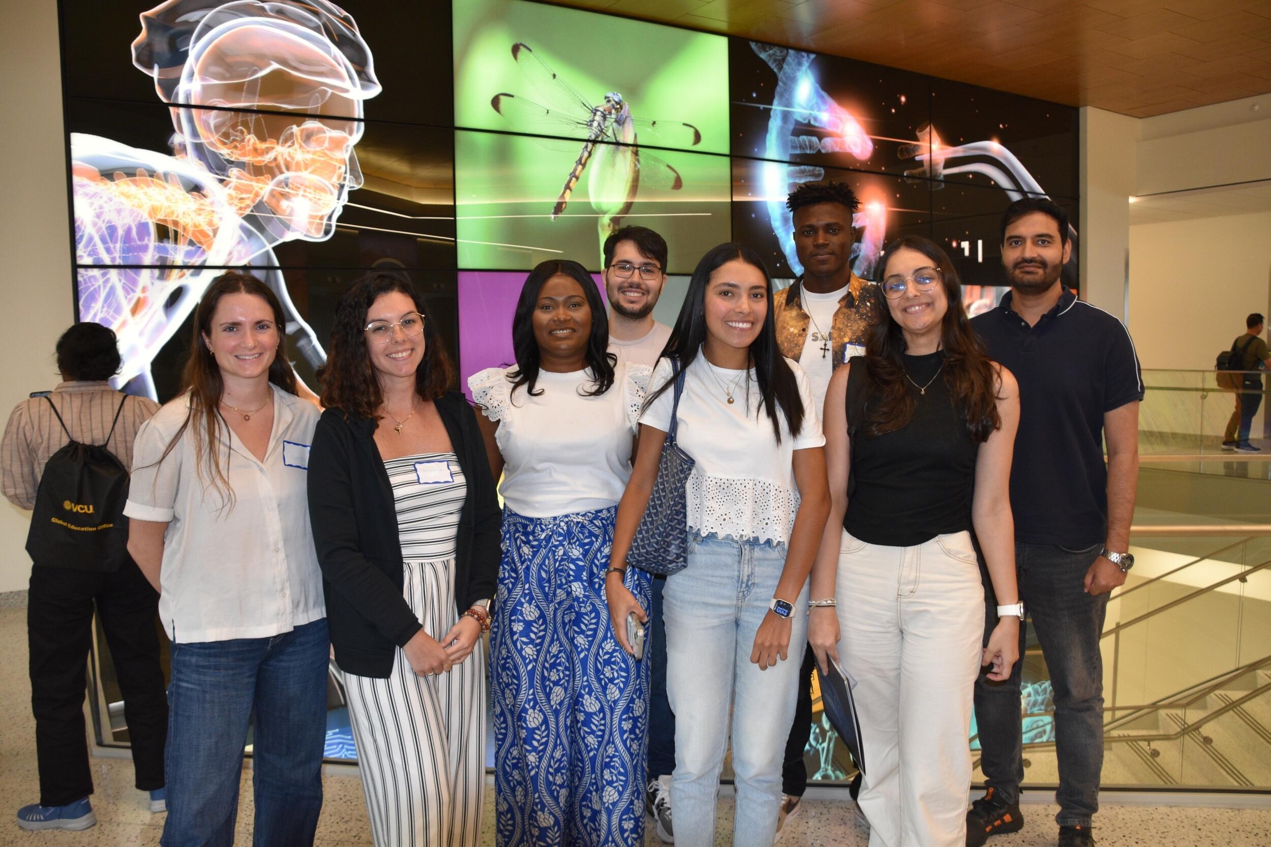 A group photo of eight people standing.