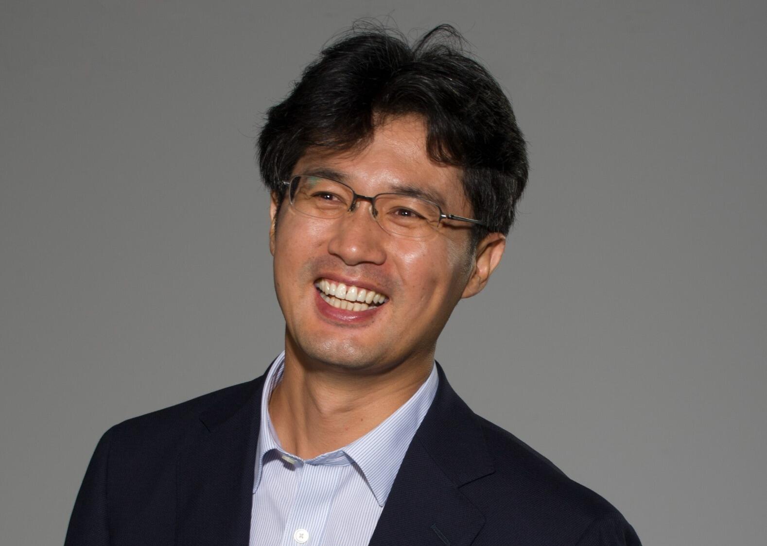 A photo of a man smiling. 