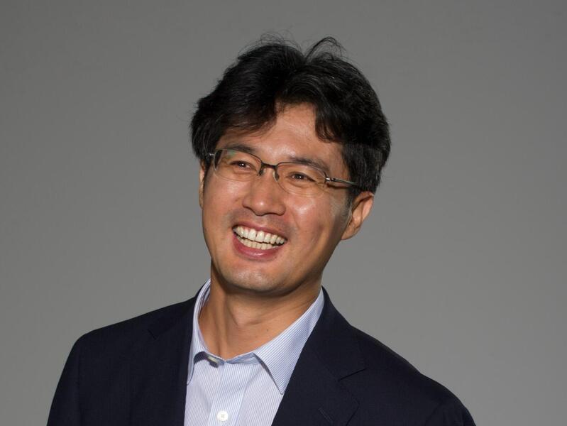 A photo of a man smiling. 