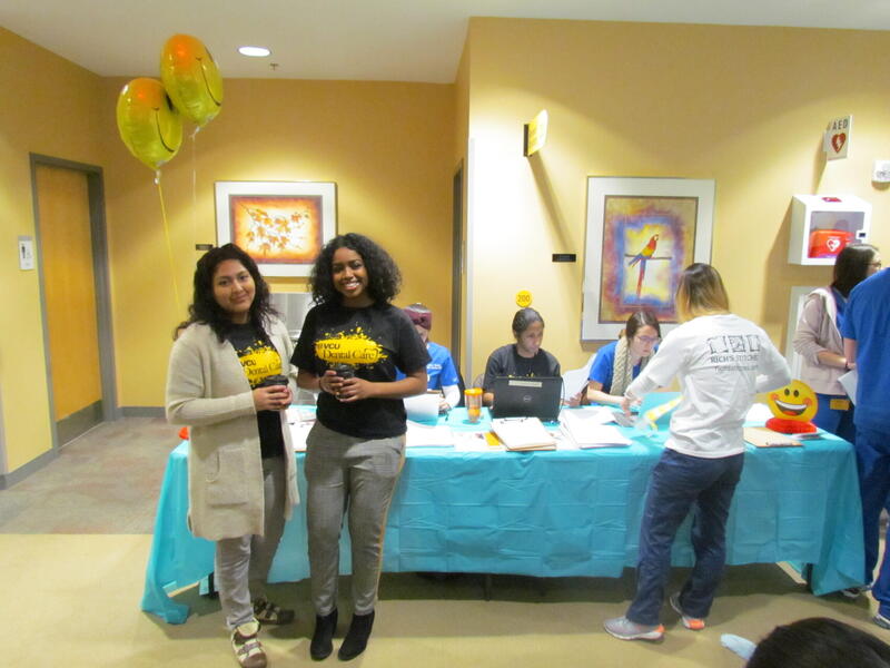 A sign-in desk at a Give Kids a Smile dentistry event.