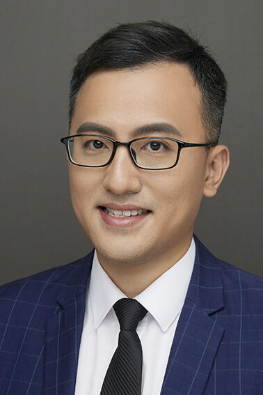 A photo of a man from the shoulders up. 