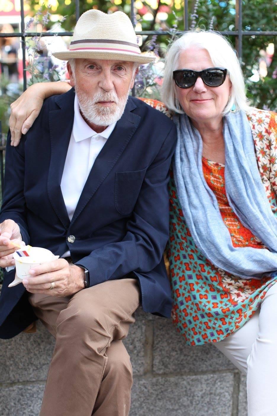A photo of a man and woman with white hair sitting next to each other. 