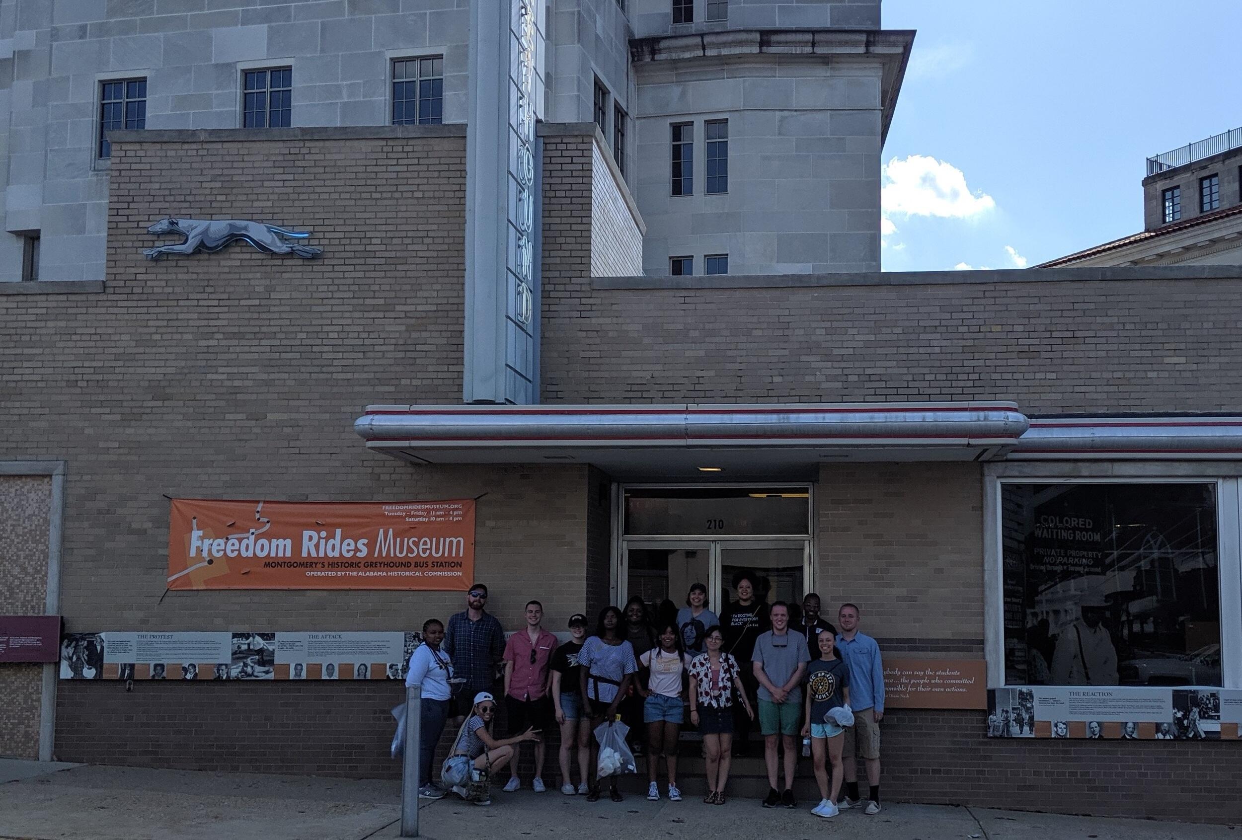 VCU students standing in front of the Freedom Rides Museum, a brick building, in Montgomery, Alabama.