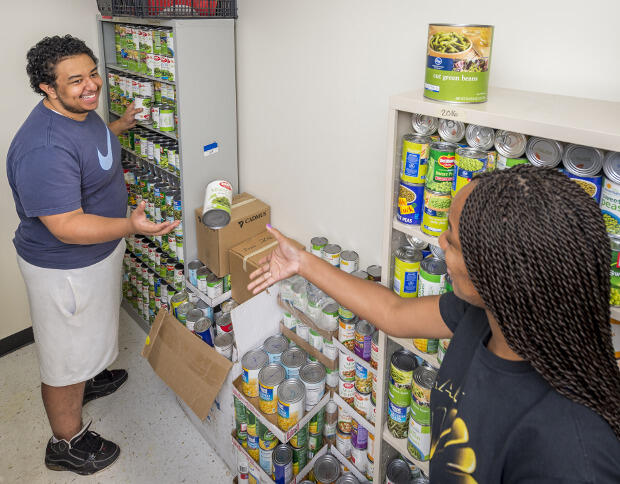 Myles Boyd, a senior chemical engineering major, and Shaniqua Thorpe, a sophomore studying early and elementary education, pair up to replenish the pantry.