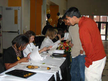 From left Latonya Cudjoe and Amy Gray of the Office of Undergraduate Admissions assist Pratik Patel and Snehal Patel with check-in and registration for VCU's Fall Open House.
