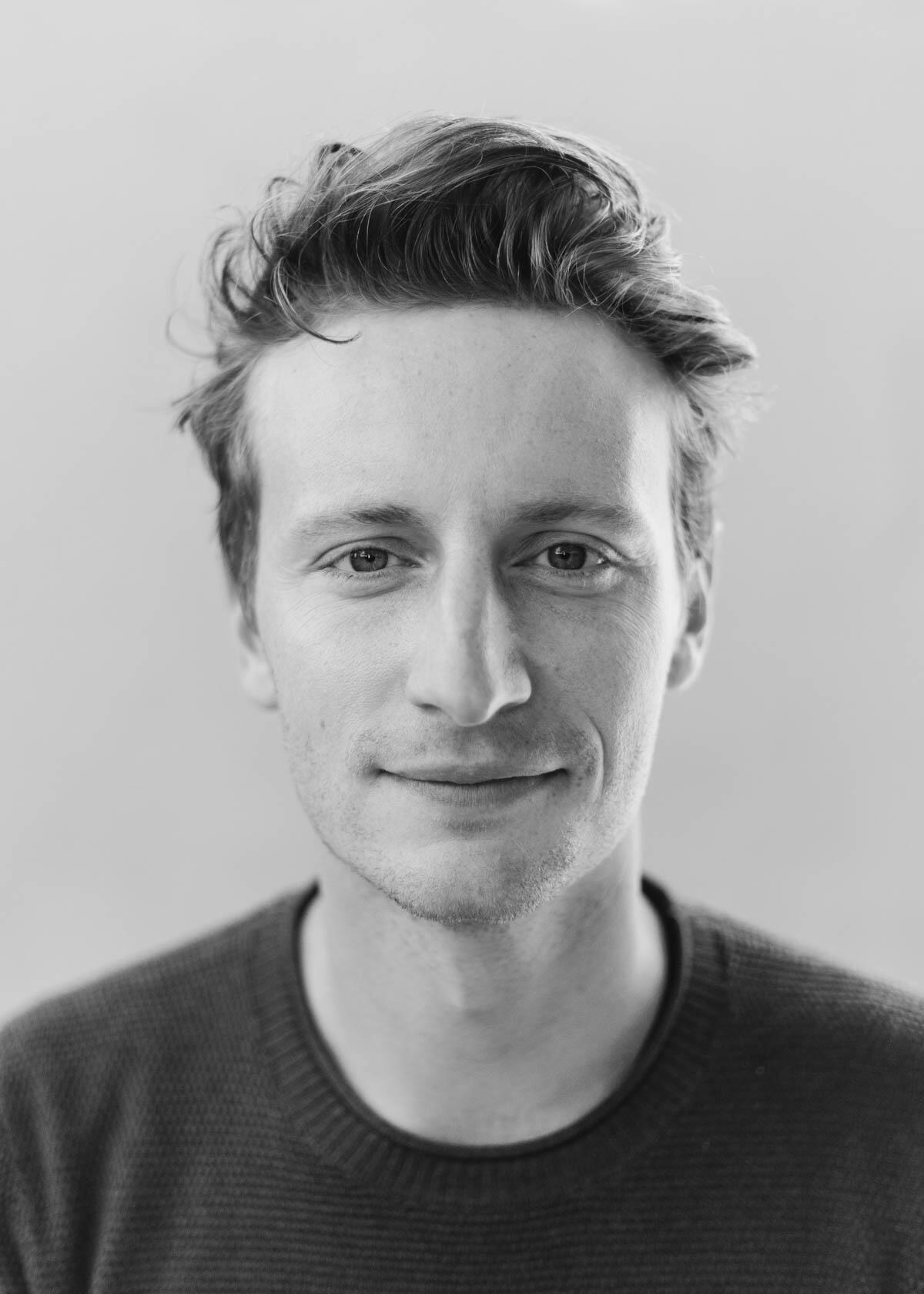 A photo of a man from the shoulders up. 