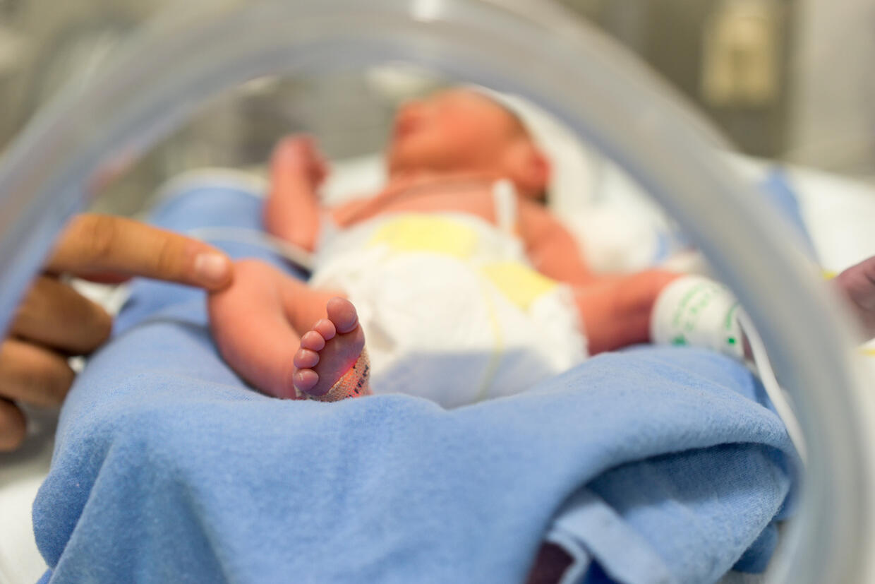 A premature baby in incubator.