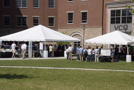 The displays and the crowds spilled outside to the courtyard at the 2009 School of Engineering Senior Design Expo, which this year included an outreach program for middle and high school students to meet with the seniors and their advisers. A list of the projects can be found at www.seniordesign.egr.vcu.edu. Photo by Melissa Gordon, VCU Communications and Public Relations.