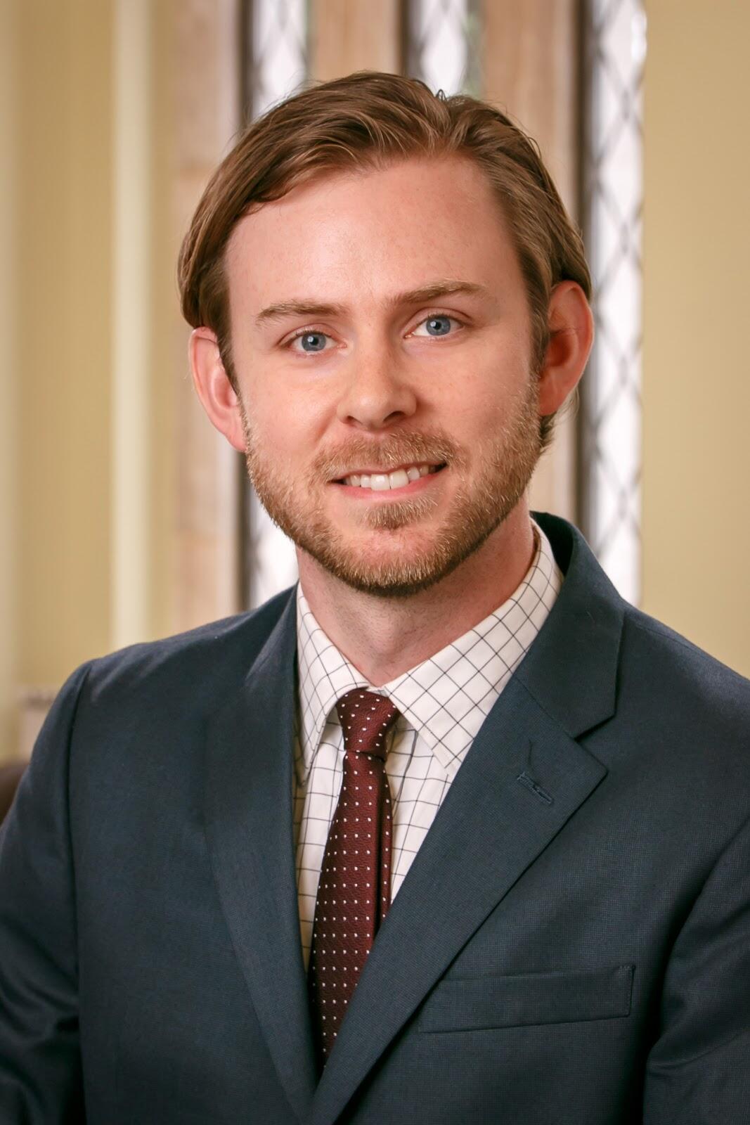 A photo of a man from the shoulders up. 