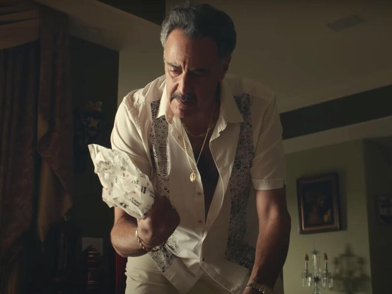 actor Brad Garrett standing over a sandwich wrapper in an advertisement for Jimmy John's sandwiches 