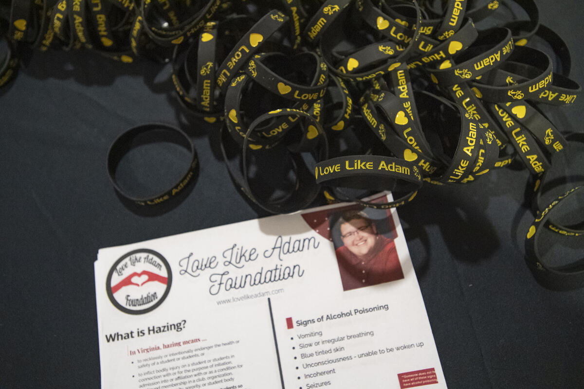 Black bracelets with yellow text that say \"Love Like Adam.\" They are next to a piece of paper that says \"Love Like Adam Foundation.\" 